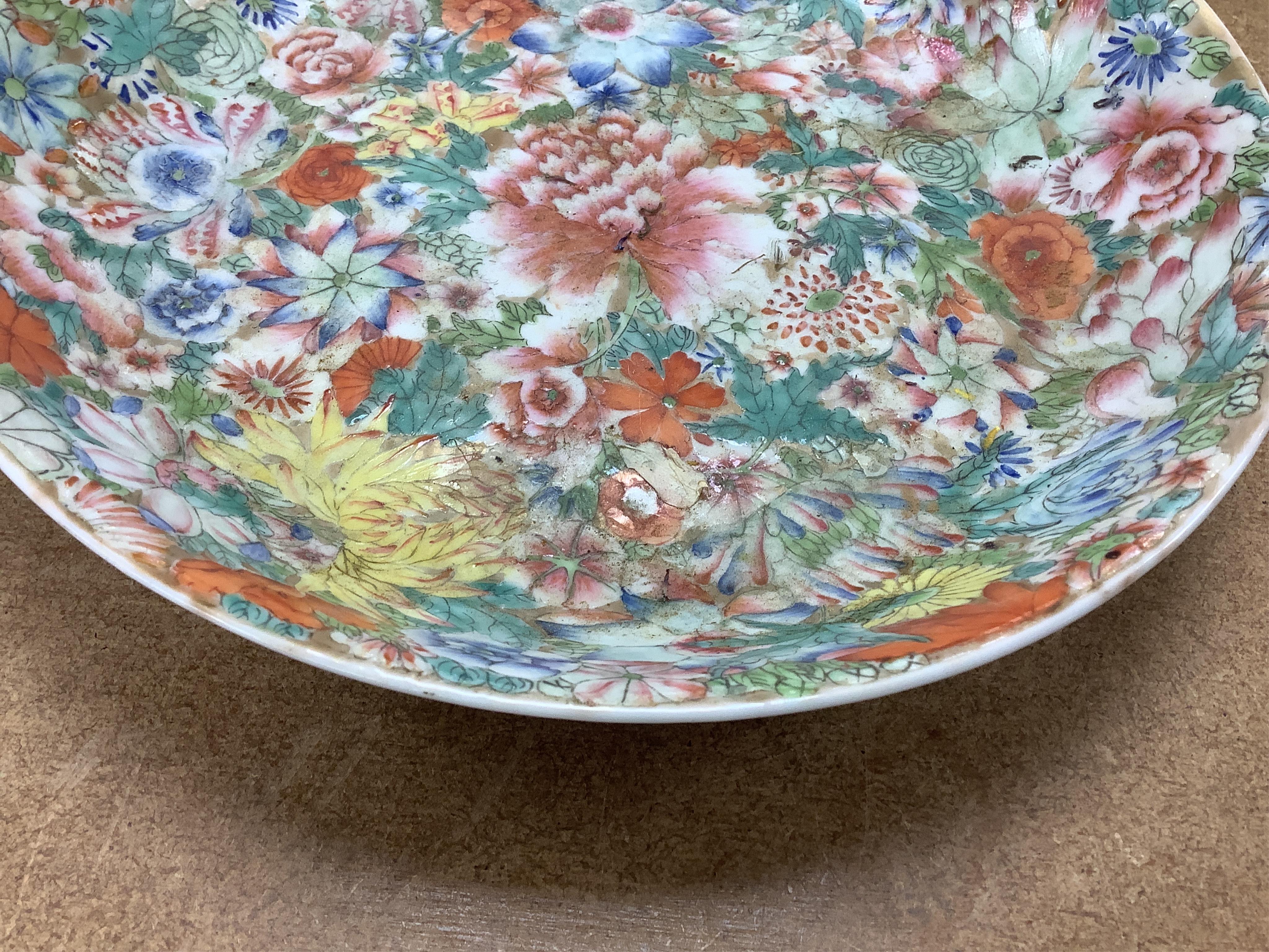 A Chinese enamelled porcelain millefleur dish, Qianlong mark, early 20th century, 24cm diameter. Condition - good